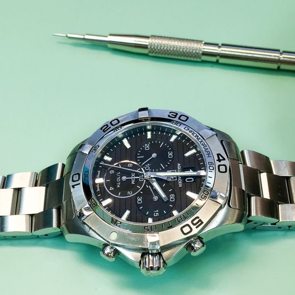 tag heuer aquaracer on a watchmakers bench