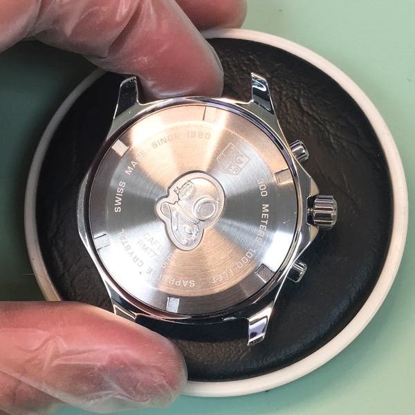 ensuring the case-back is properly fitted into the Aquaracer casing and sealed